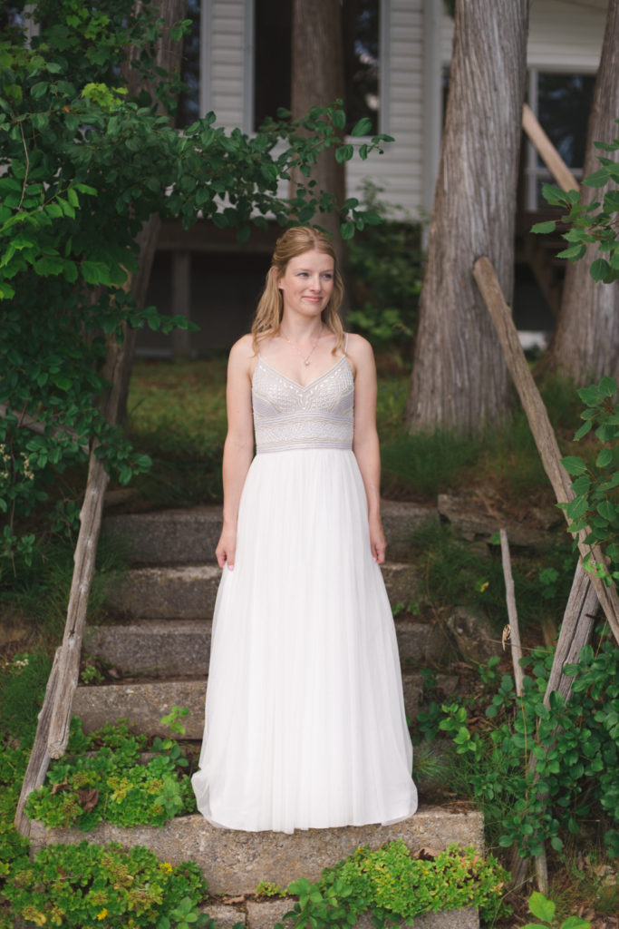 bride standing on old stone steps at the cottage