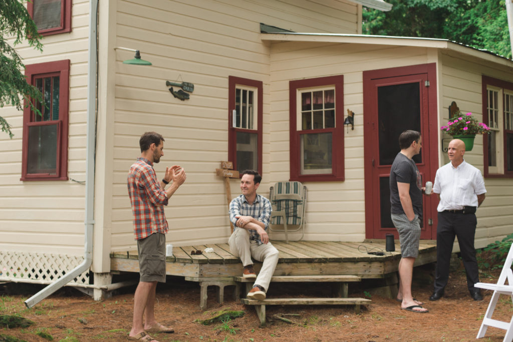 groomsmen hanging out at the cottage before the wedding ceremony