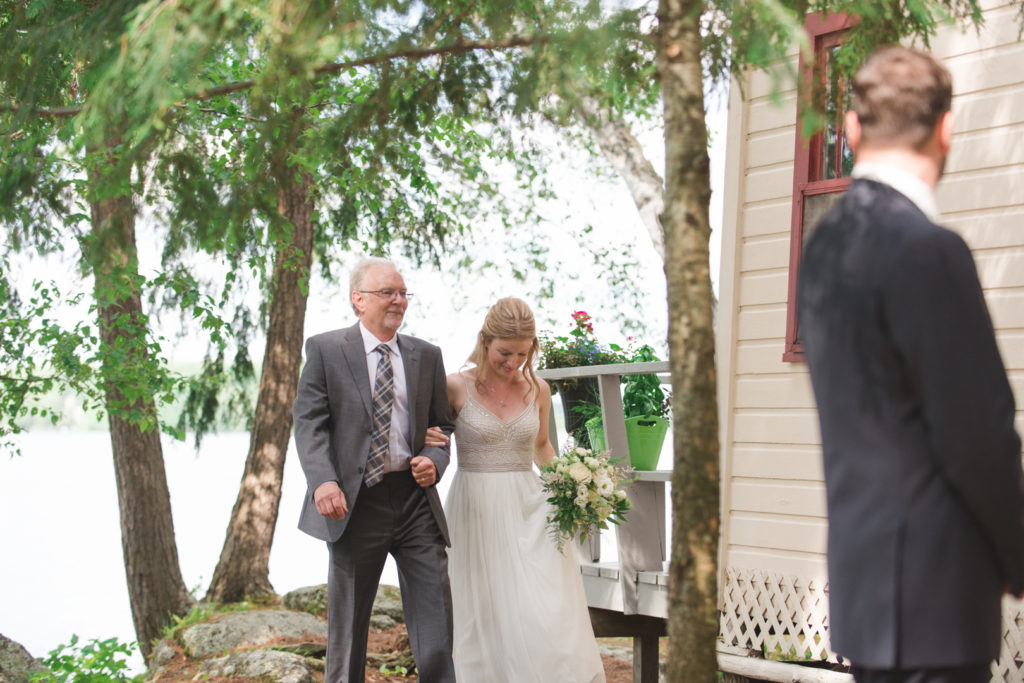 father walking his daughter up to her cottage ceremony