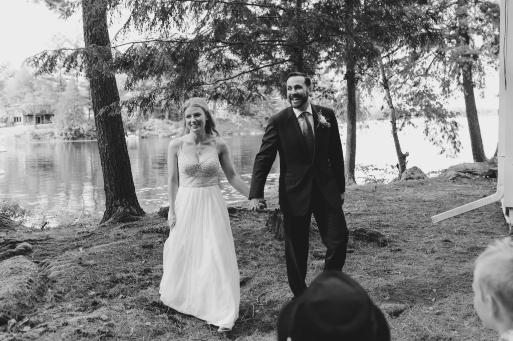 bride and groom recessional after wedding ceremony by the lake