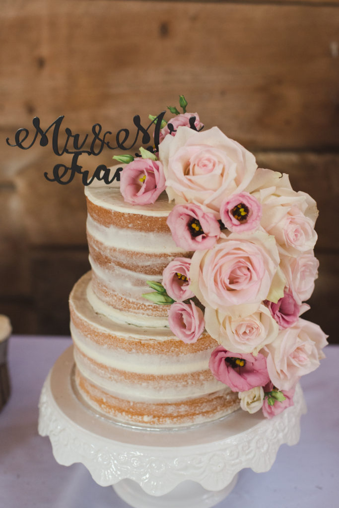 naked wedding cake with pink roses