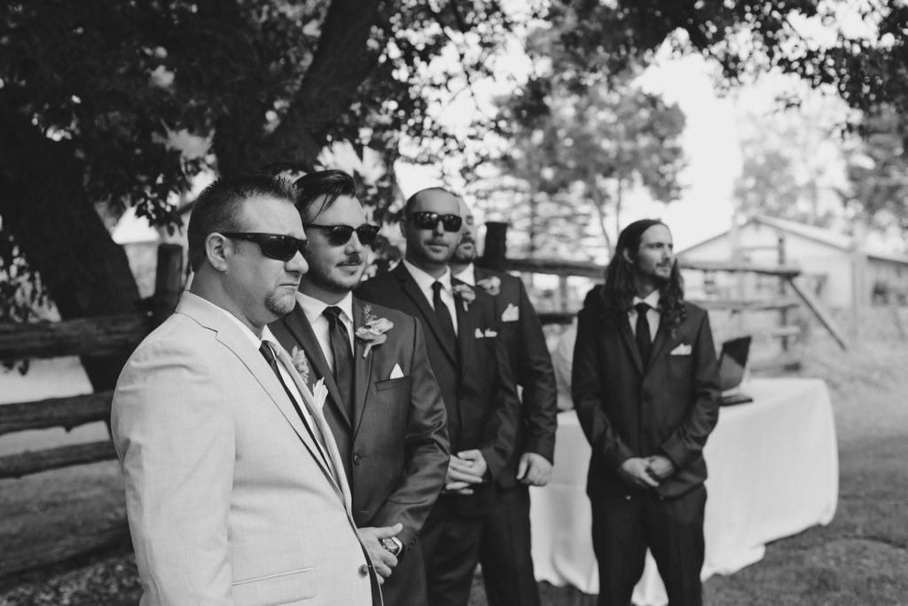 groom seeing his bride for the first time wearing sunglasses