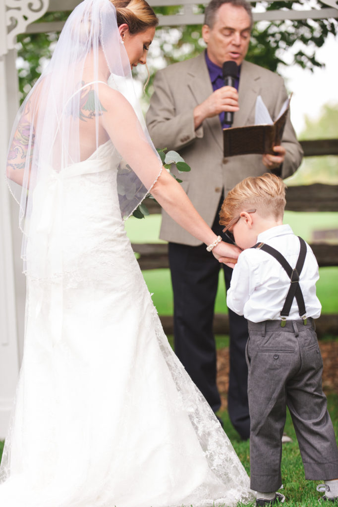 son kissing his mom's hand at the altar