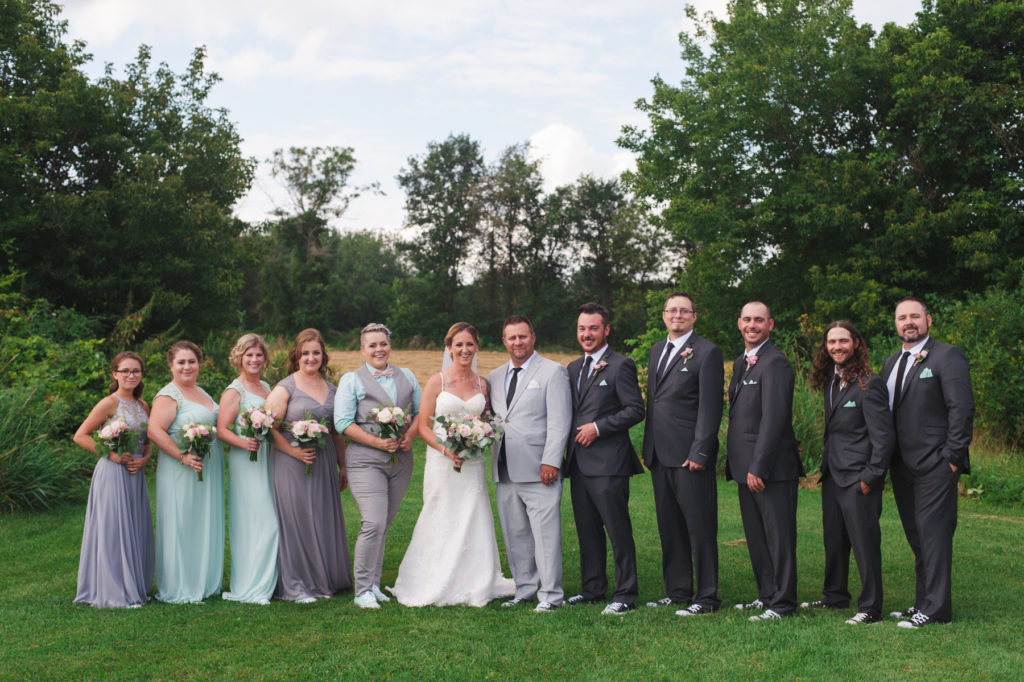 wedding party in front of field