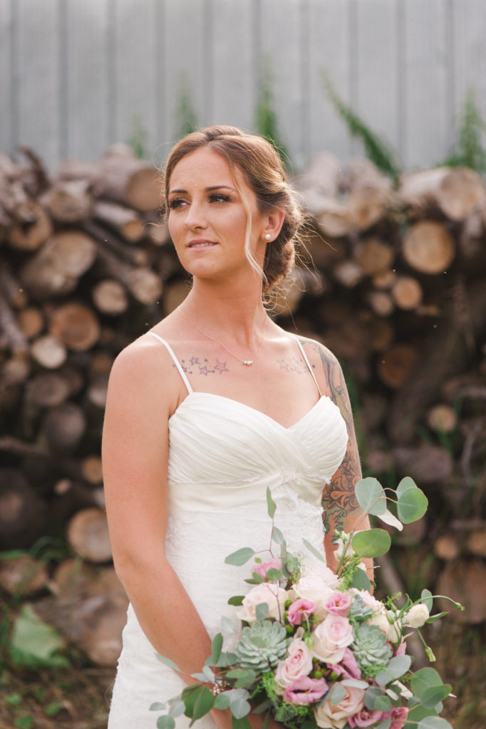 bride looking off into the distance holding her bouquet