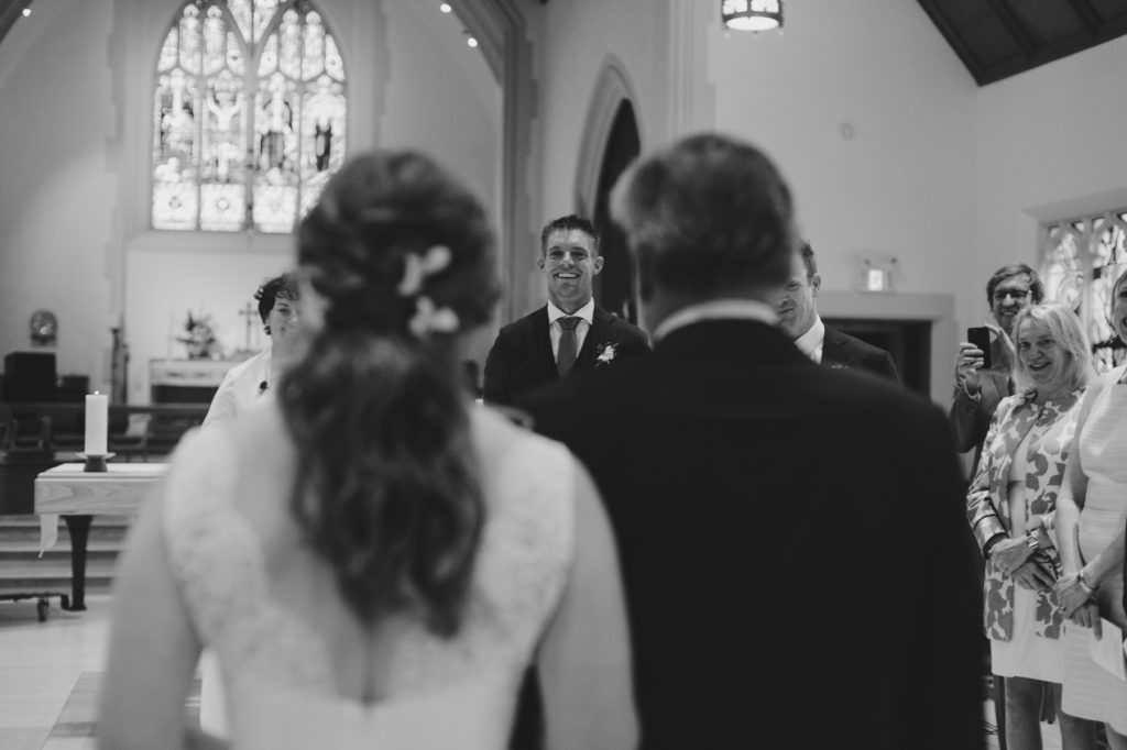 groom seeing the bride for the first time at church wedding