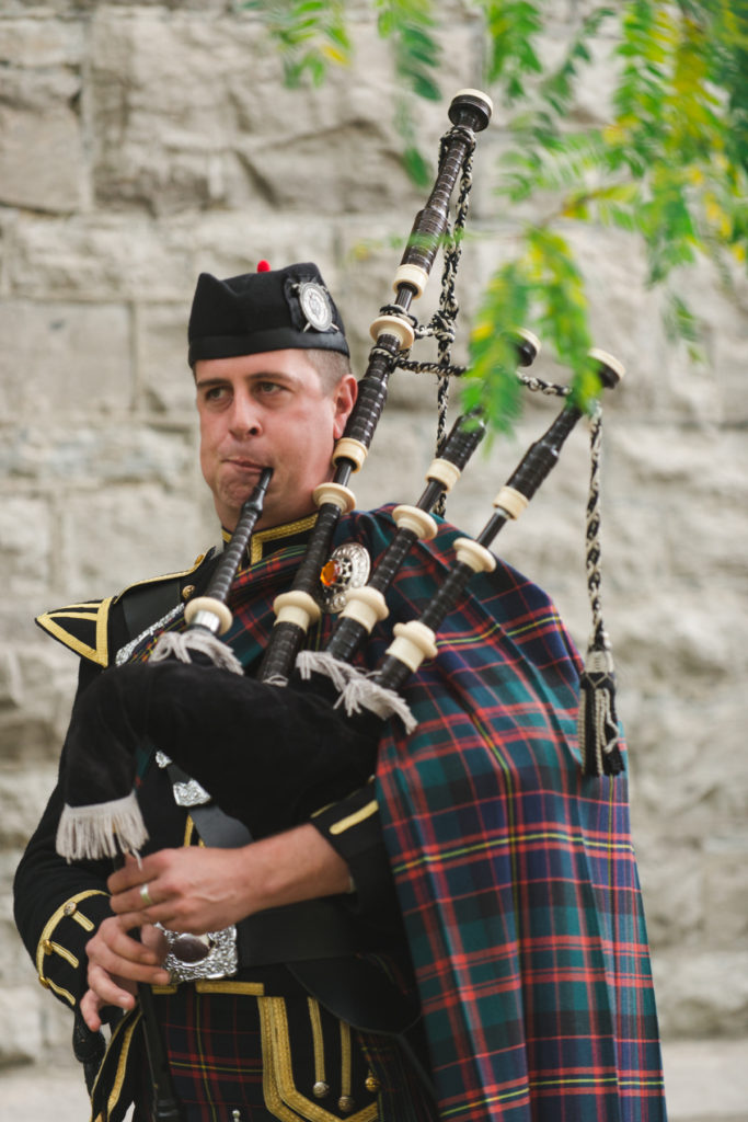 bag piper outside of church wedding following ceremony