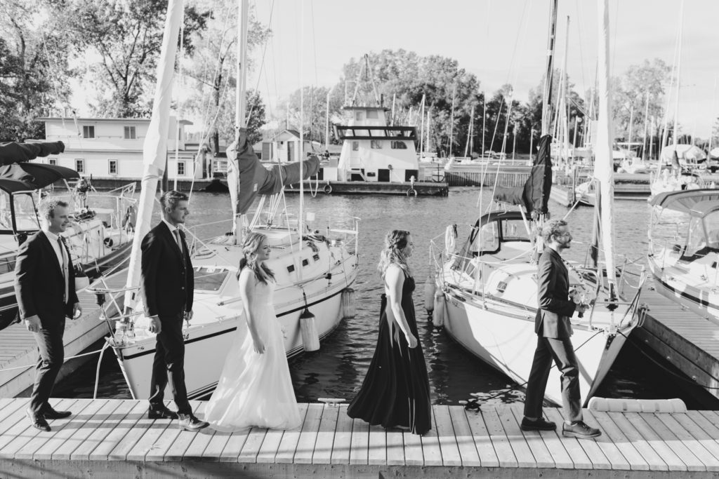 wedding party abbey road photo in front of sail boats