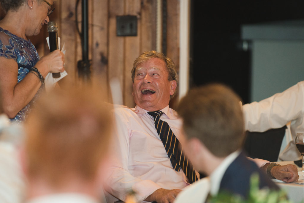 bride's father laughing at mother's speech