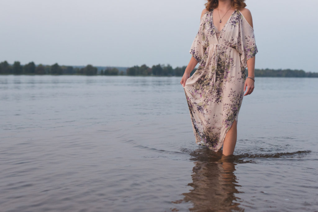 redheard walking in the water with flowing dress