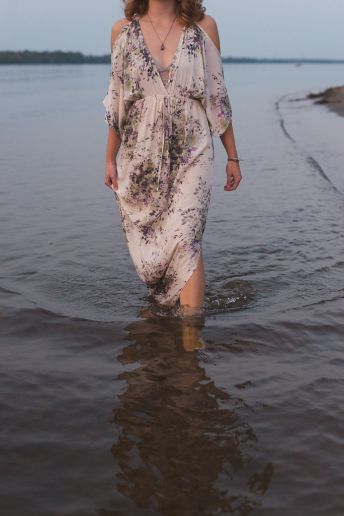 redheard walking in the water with flowing dress