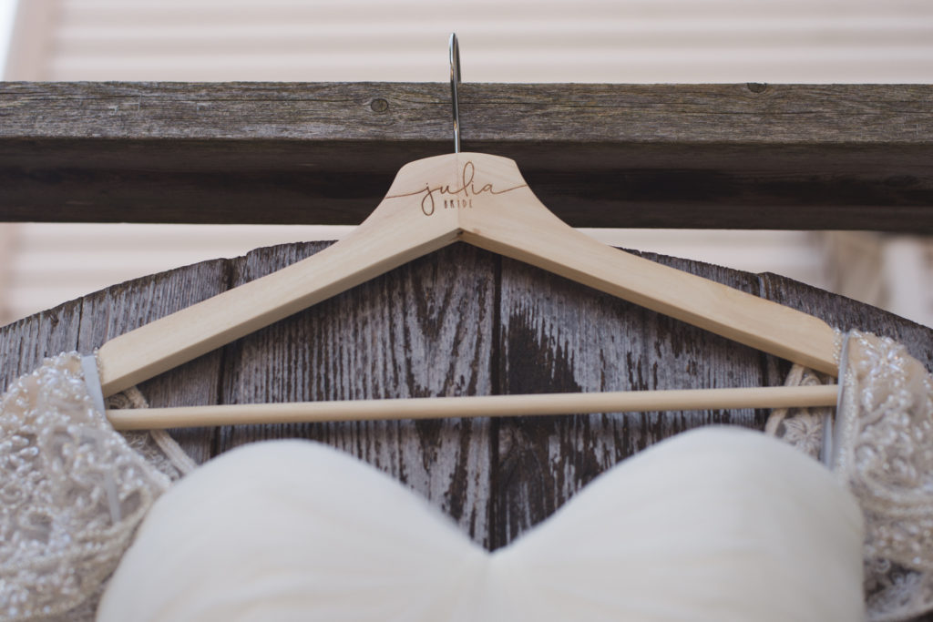 wooden hanger with bride's name etched in