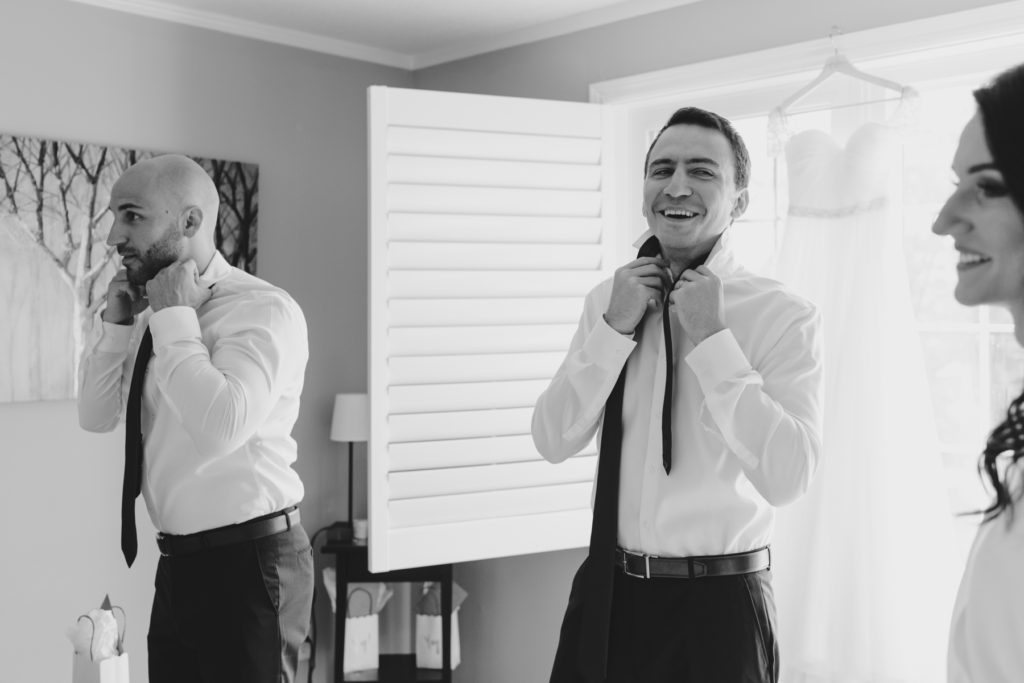 bride and male bridesmaids getting ready