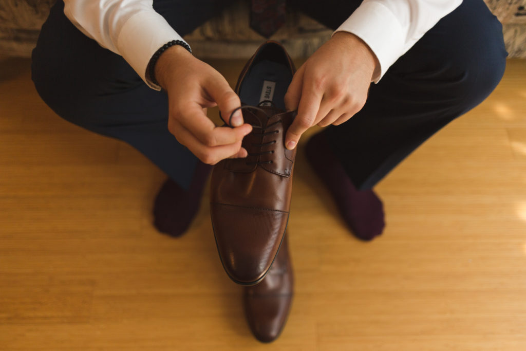 groom putting on his shoes
