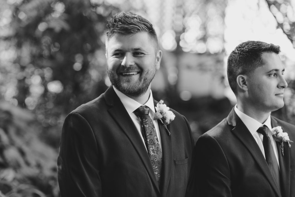 groom smiling as he sees his bride for the first time