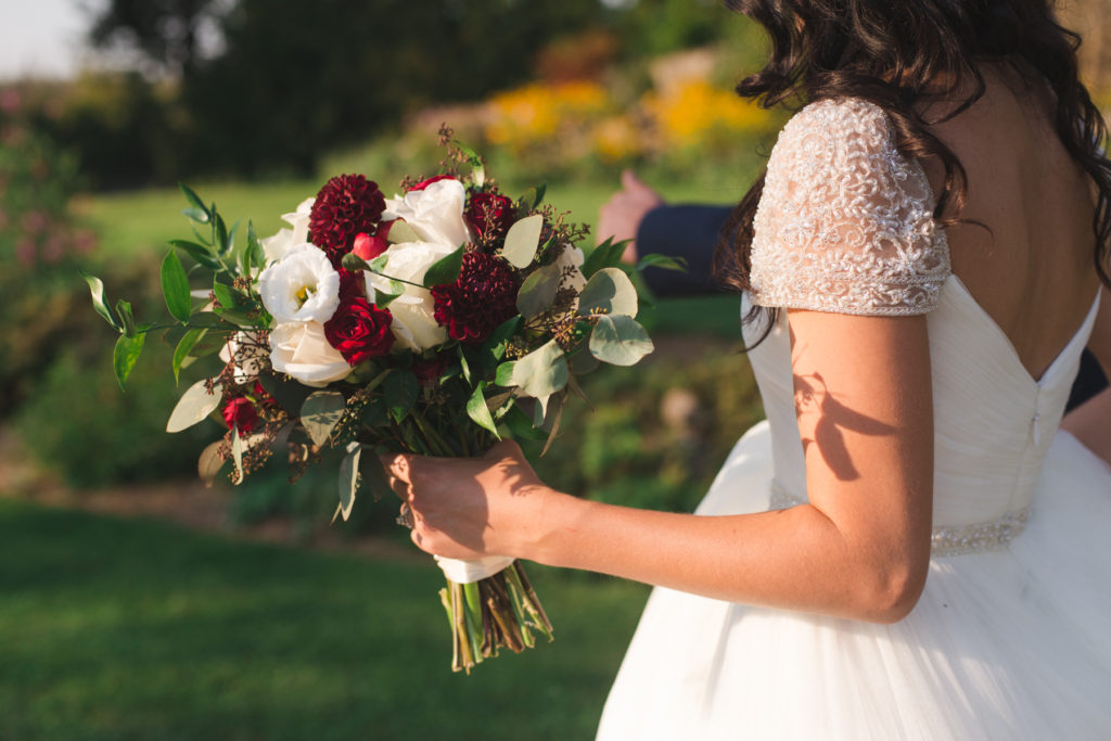 bride walking into the sunset with her bouquet