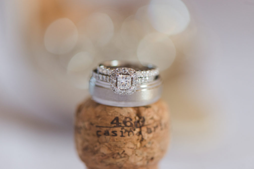 wedding rings on top of champagne cork