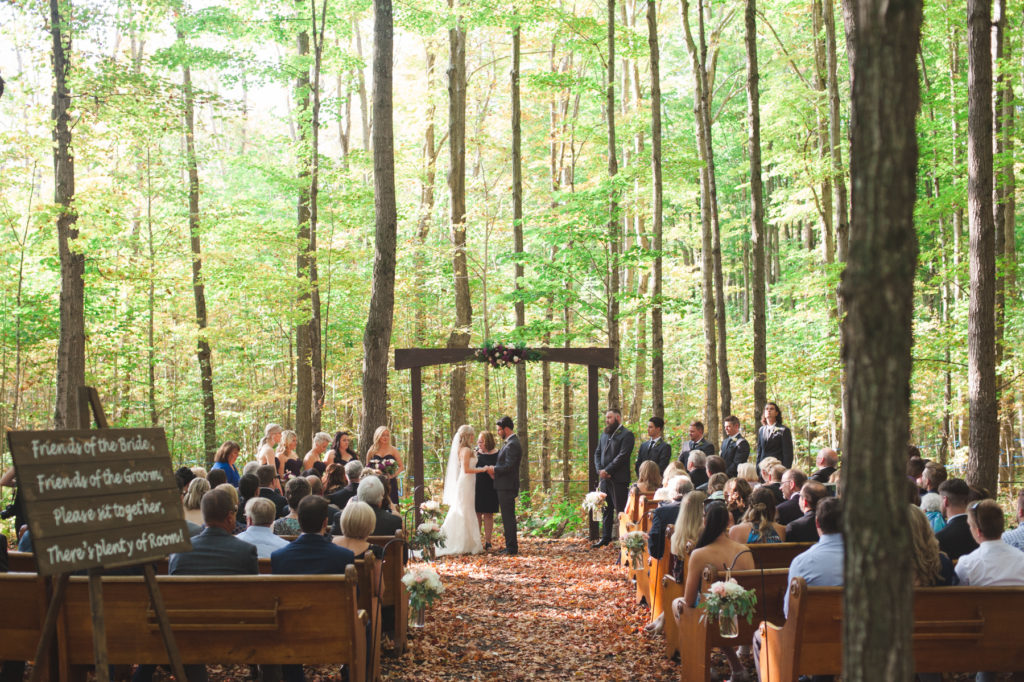 ceremony in the forrest with church pews
