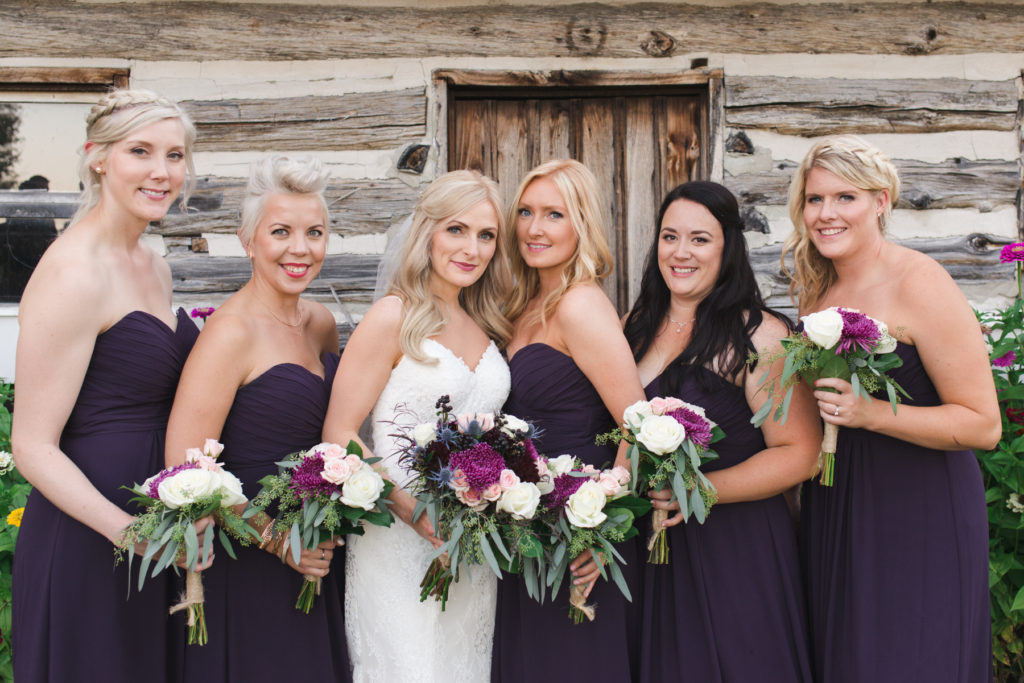 bride and bridesmaids in purple