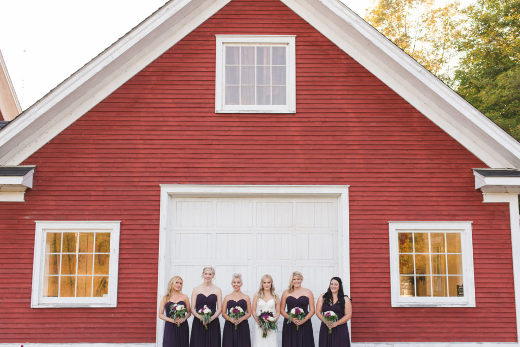bridesmaids in front of red cabin