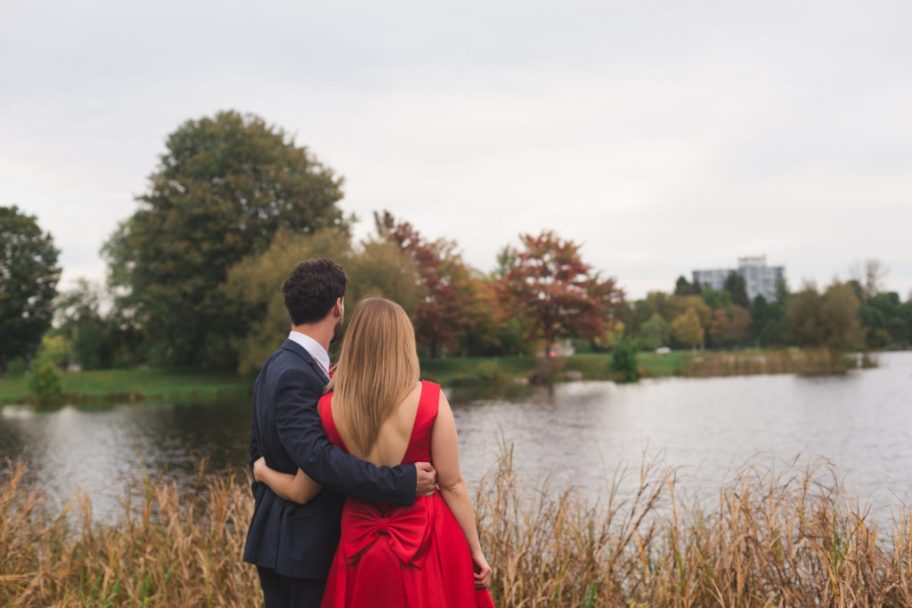 engaged couple looking out onto the water