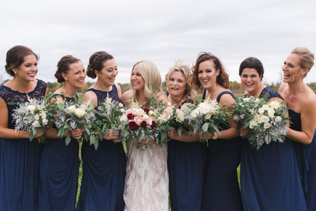 bridesmaids laughing together on overcast day