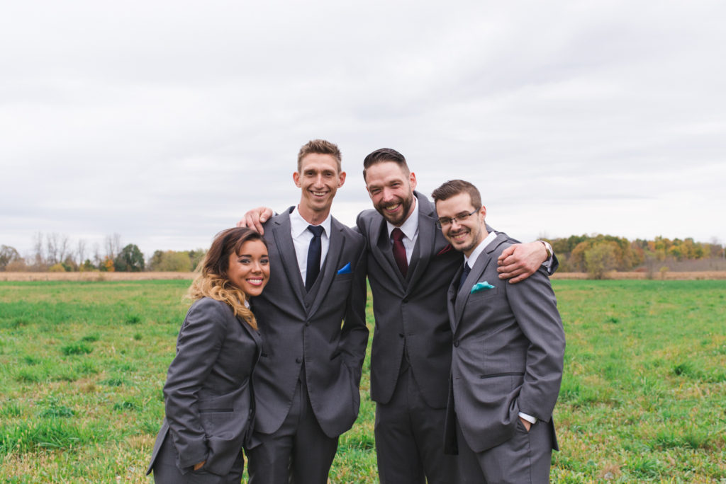 groomsmen smiling for the camera