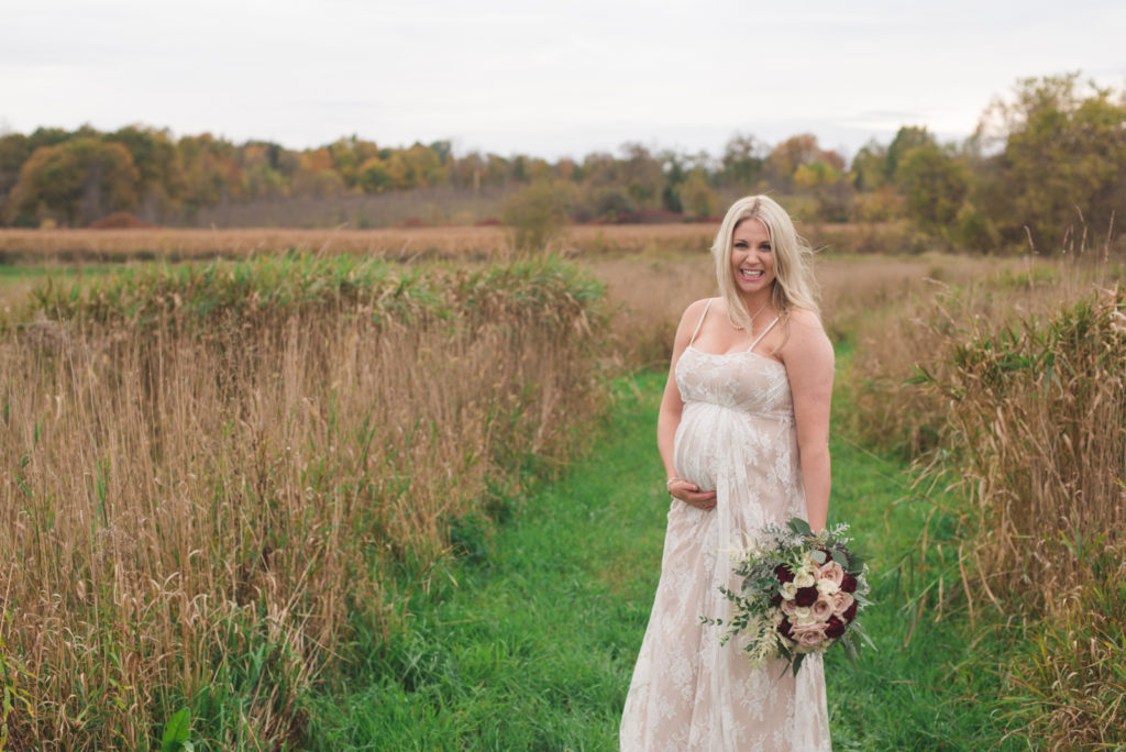 pregnant bride standing in fields of Strathmere