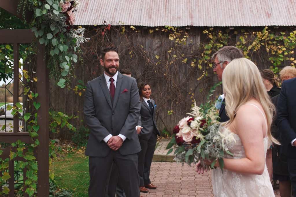 Groom seeing his bride at the end of the aisle at Strathmere