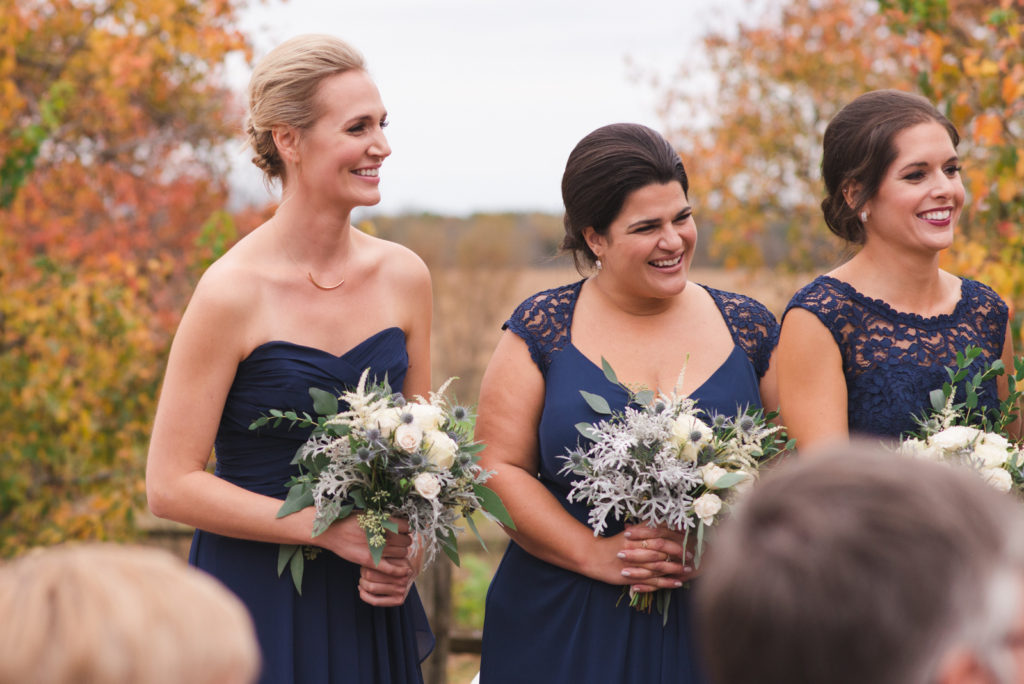 bridesmaids laughing during outdoor ceremony
