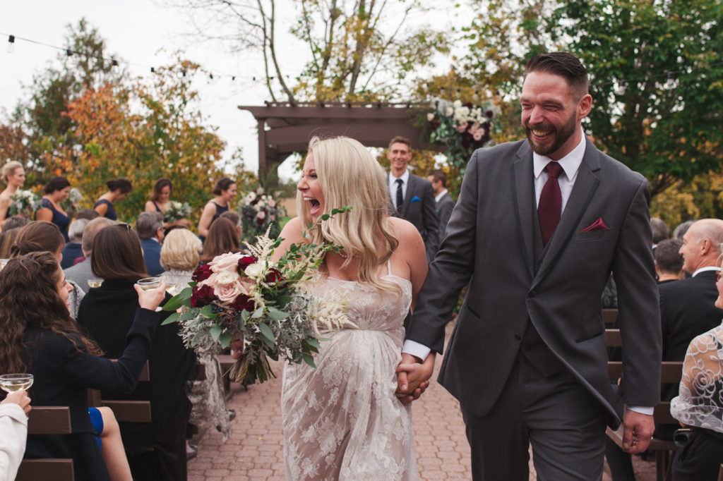 bride and groom laughing during recessional