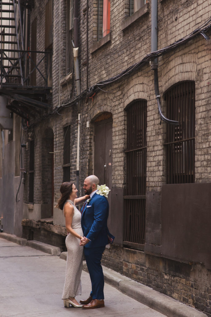 bride and groom standing in alley in Toronto