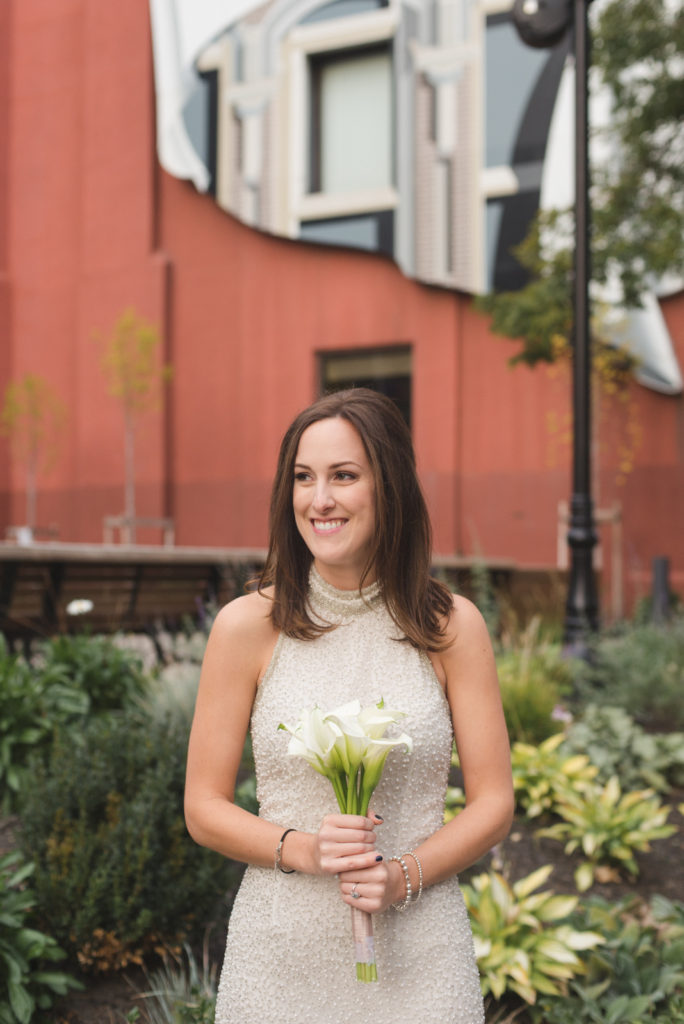 bride in vintage gown holding bouquet of calla lillies