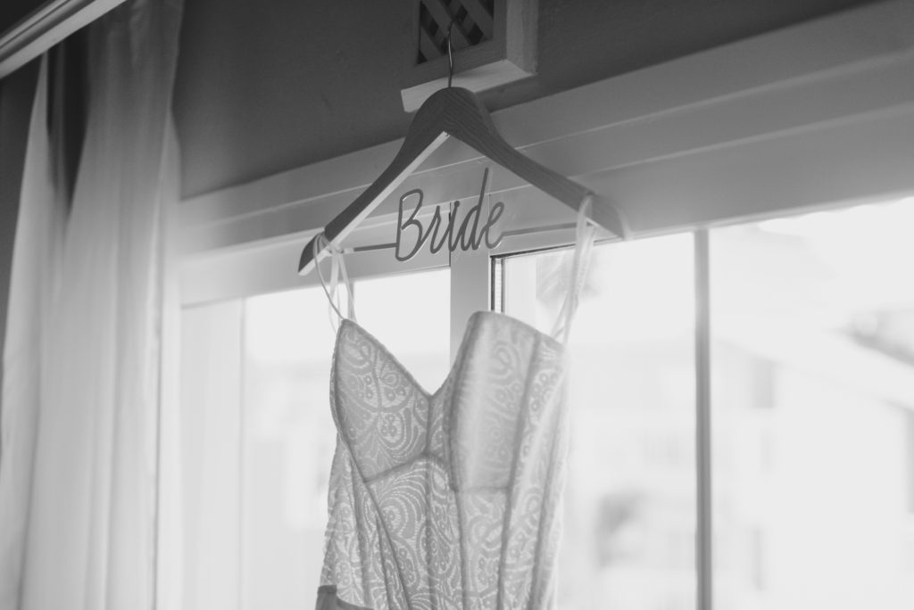 wedding dress hanging from "bride" hanger