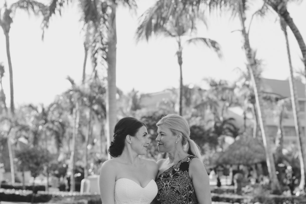 bride and her mother smiling at each other