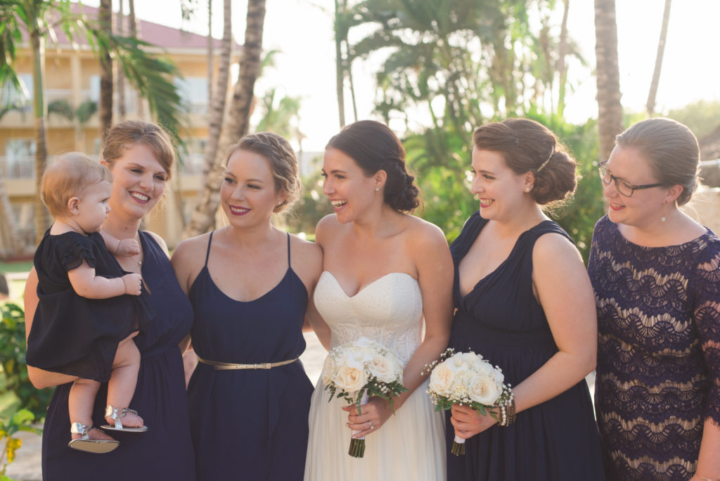 bridesmaids smiling at the flower girl