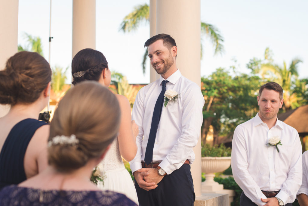 groom smiling at his bride during ceremony