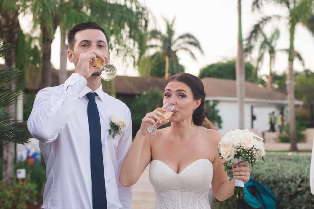 bride and groom sipping champagne after wedding ceremony