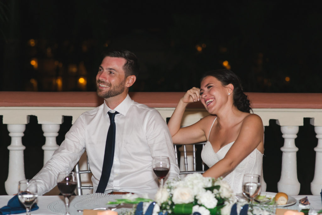 bride and groom laughing at speeches