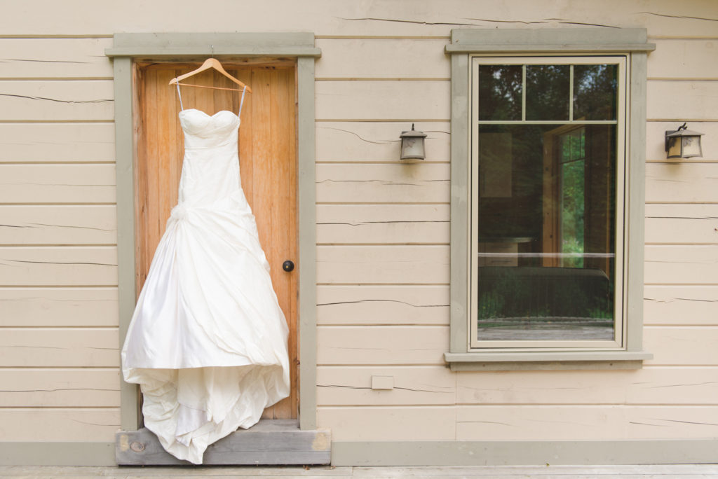 bride's dress hanging outside the door of the guest house