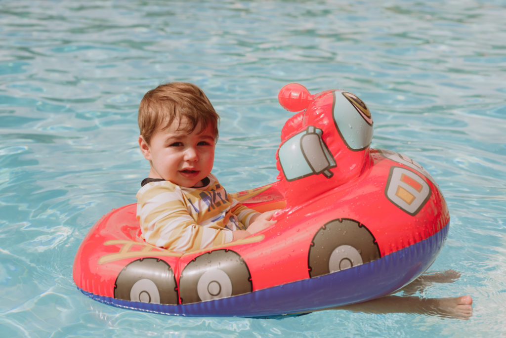 Little boy in the pool on fire truck floaty