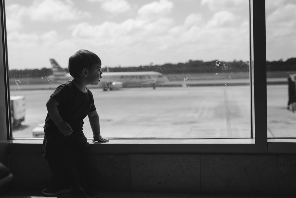 little boy watching the planes land at the airport