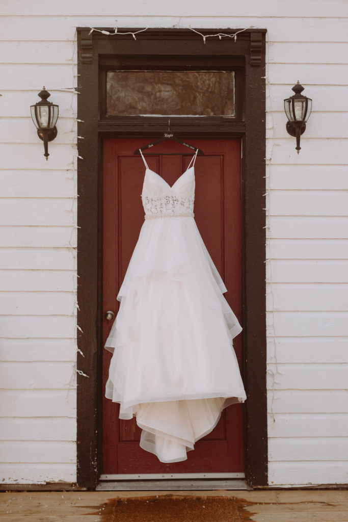 Bride's dress hanging from the school house door at Strathmere