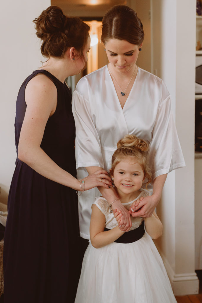 bride and flower girl getting ready