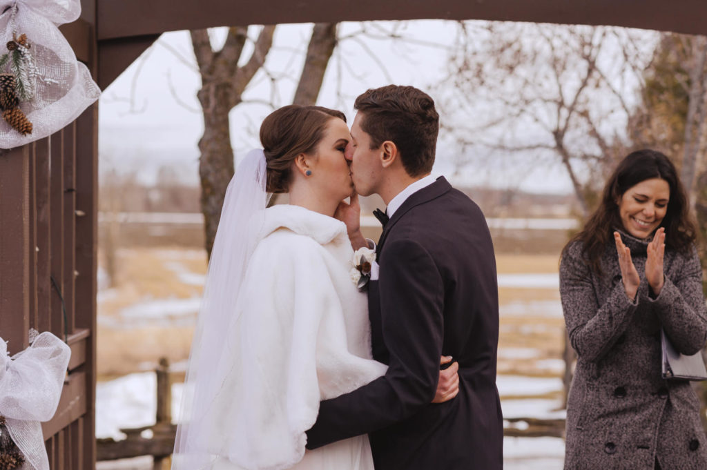 first kiss during outdoor winter wedding