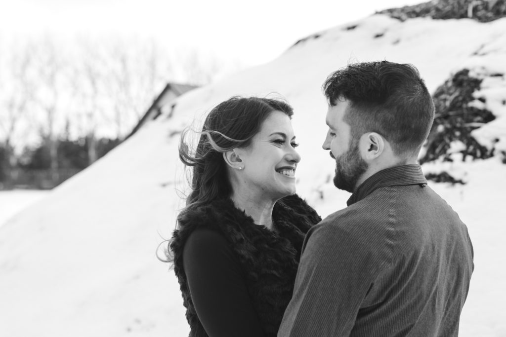 girl smiling at her boyfriend in black and white