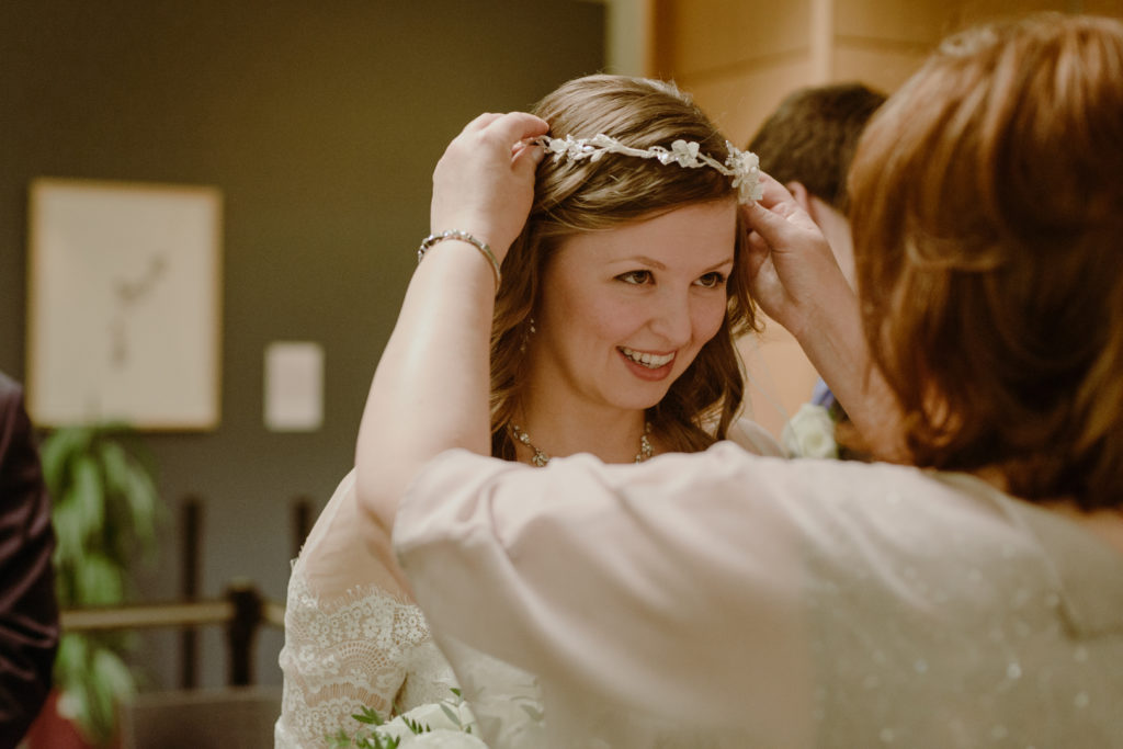 mother of the bride adjusting the bride's veil