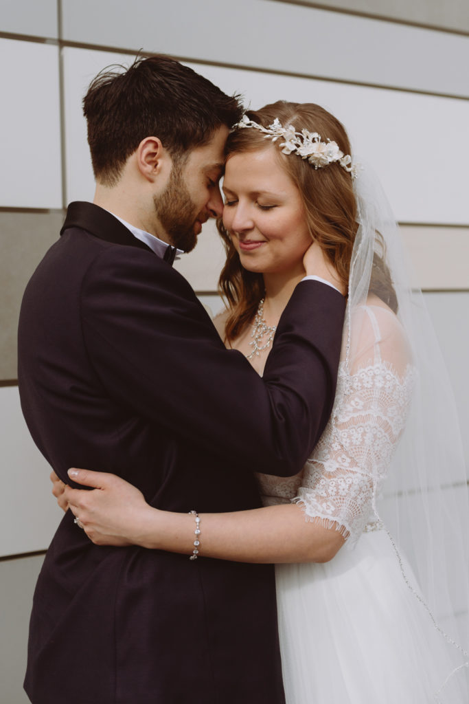 bride and groom snuggling close