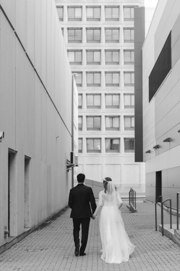 bride and groom walking together holding hands