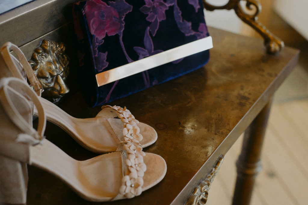 wedding shoes and purple velvet clutch